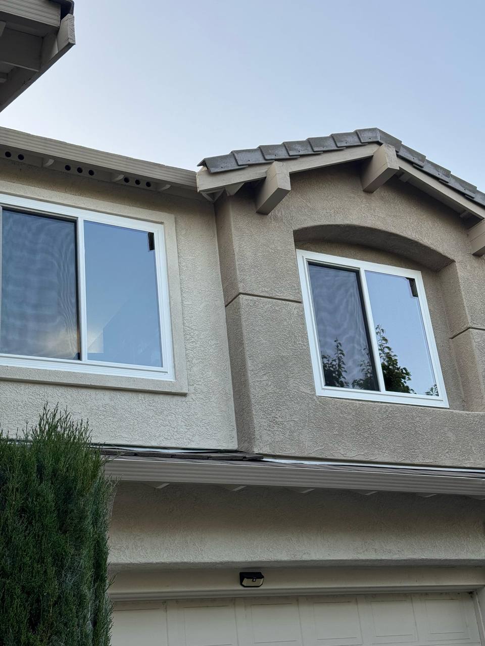 Twin window installation on stucco façade