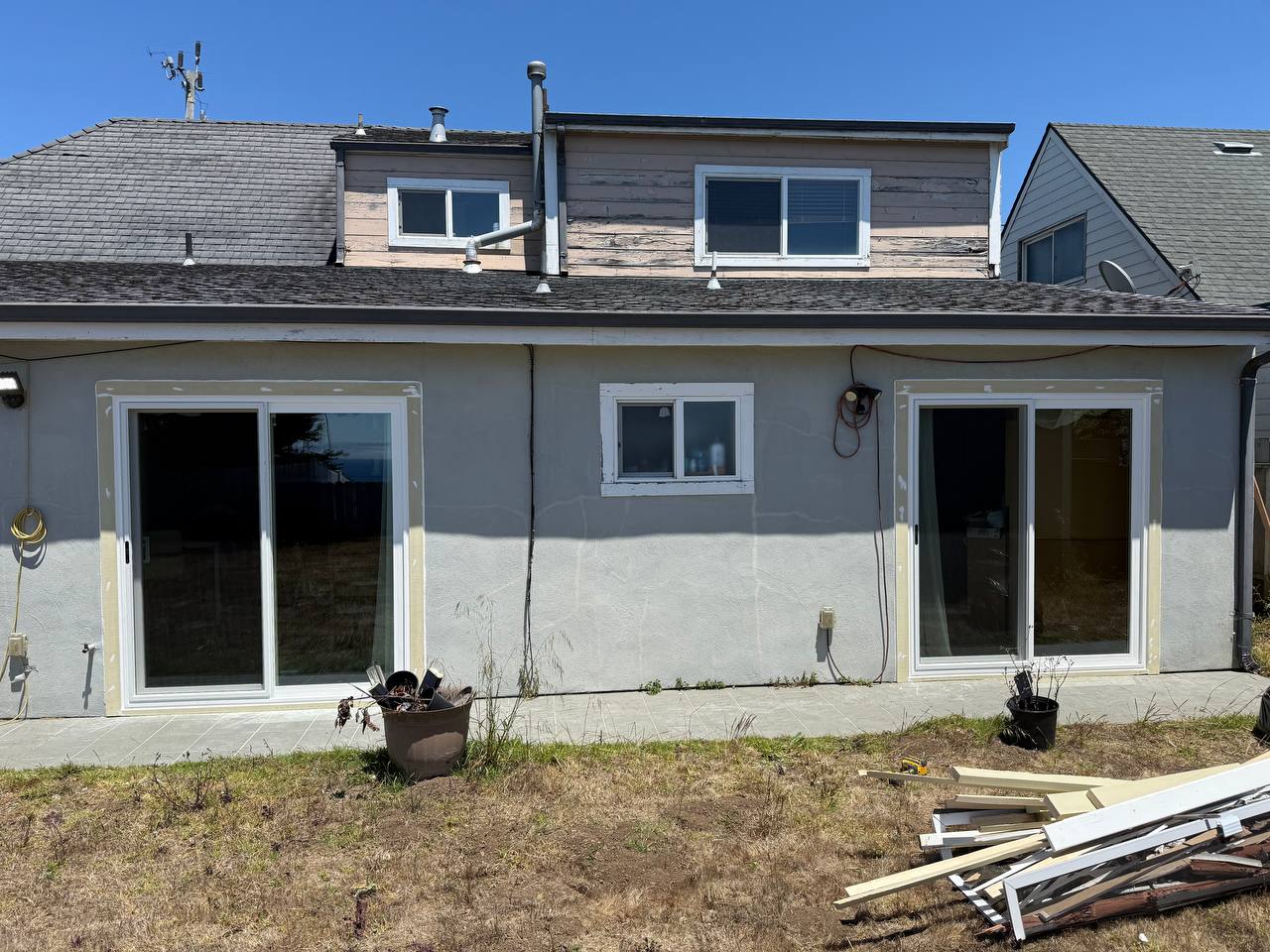 Rear façade with sliding glass doors — completed project