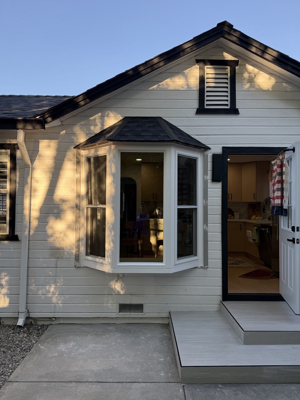 Finished bay window installation with warm interior light, completed by Milari